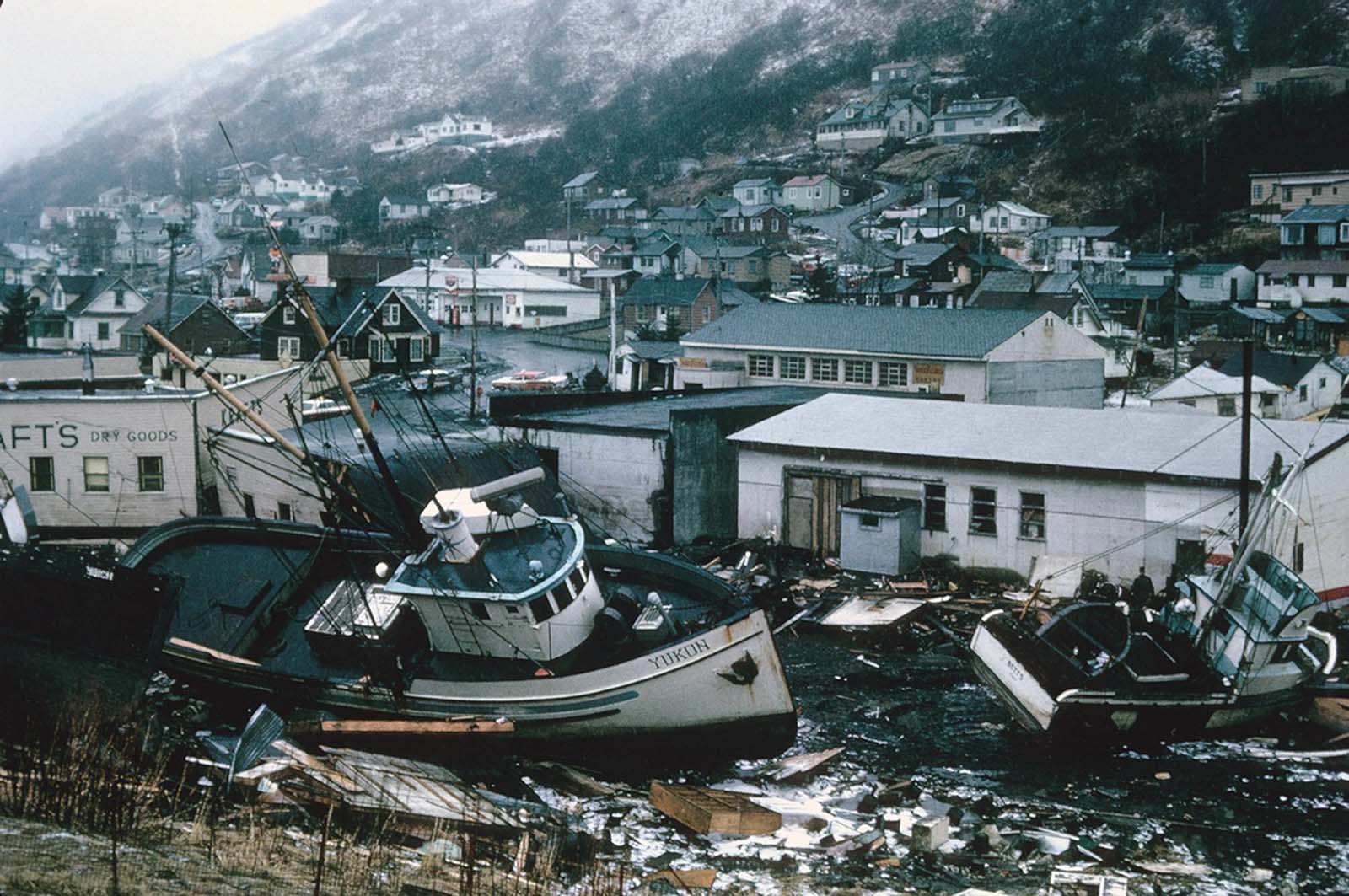 Chaotic condition of the commercial section of Kodiak following inundation by seismic sea waves. The small boat harbor contained an estimated 160 crab and salmon fishing boats when the waves struck.