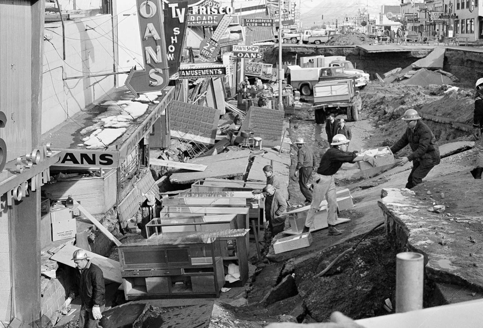 Anchorage small business owners clear salvageable items and equipment from their earthquake-ravaged stores on shattered Fourth Avenue, in the aftermath of the quake.