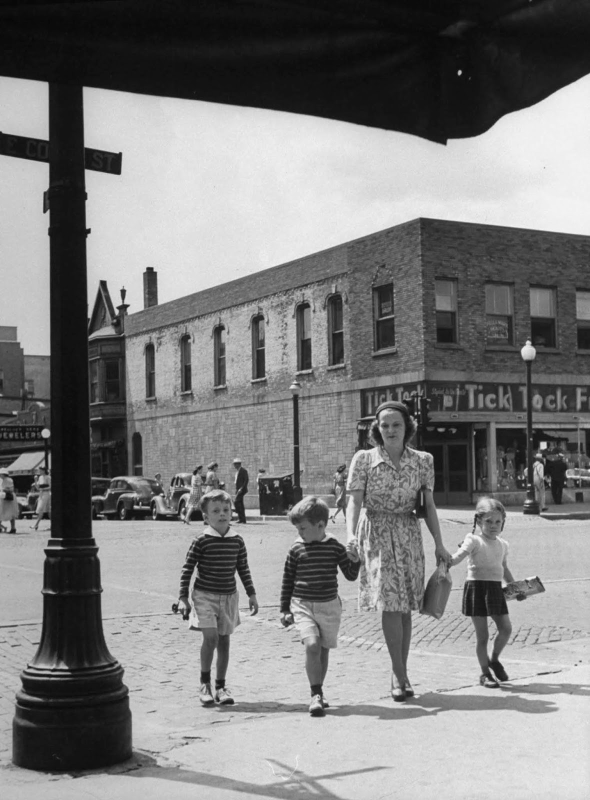 Jane with Peter, Tony and Pamela, as they go to the drugstore to buy ice cream cones, after the boys had haircuts at local barbershop in town.