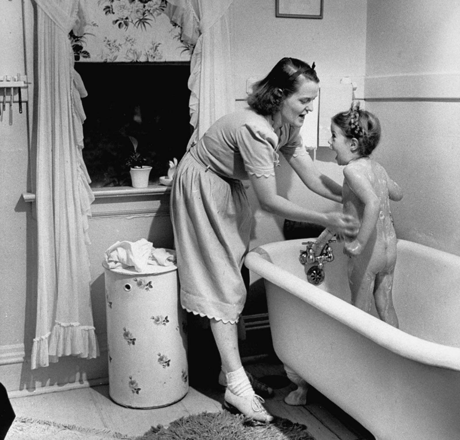Jane bathing her daughter Pamela, 4, before dressing her for bed at night.