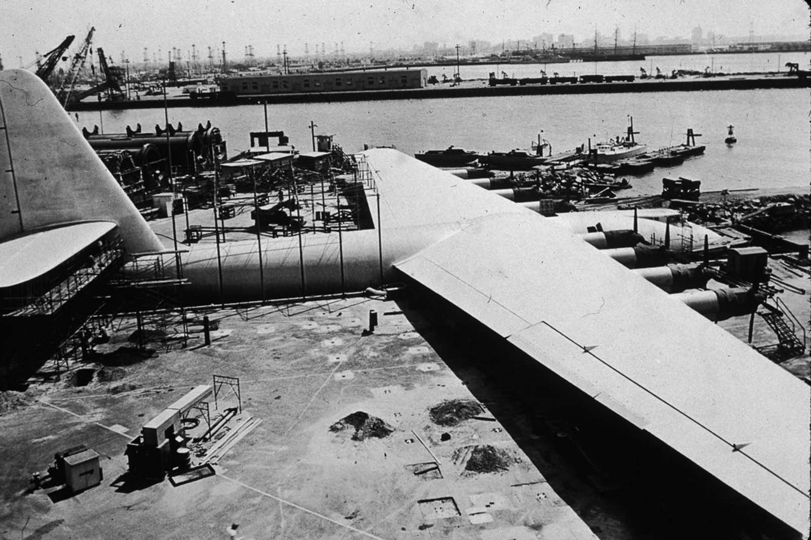 A house moving company transported the airplane on streets to Pier E in Long Beach, California. They moved it in three large sections: the fuselage, each wing—and a fourth, smaller shipment with tail assembly parts and other smaller assemblies.