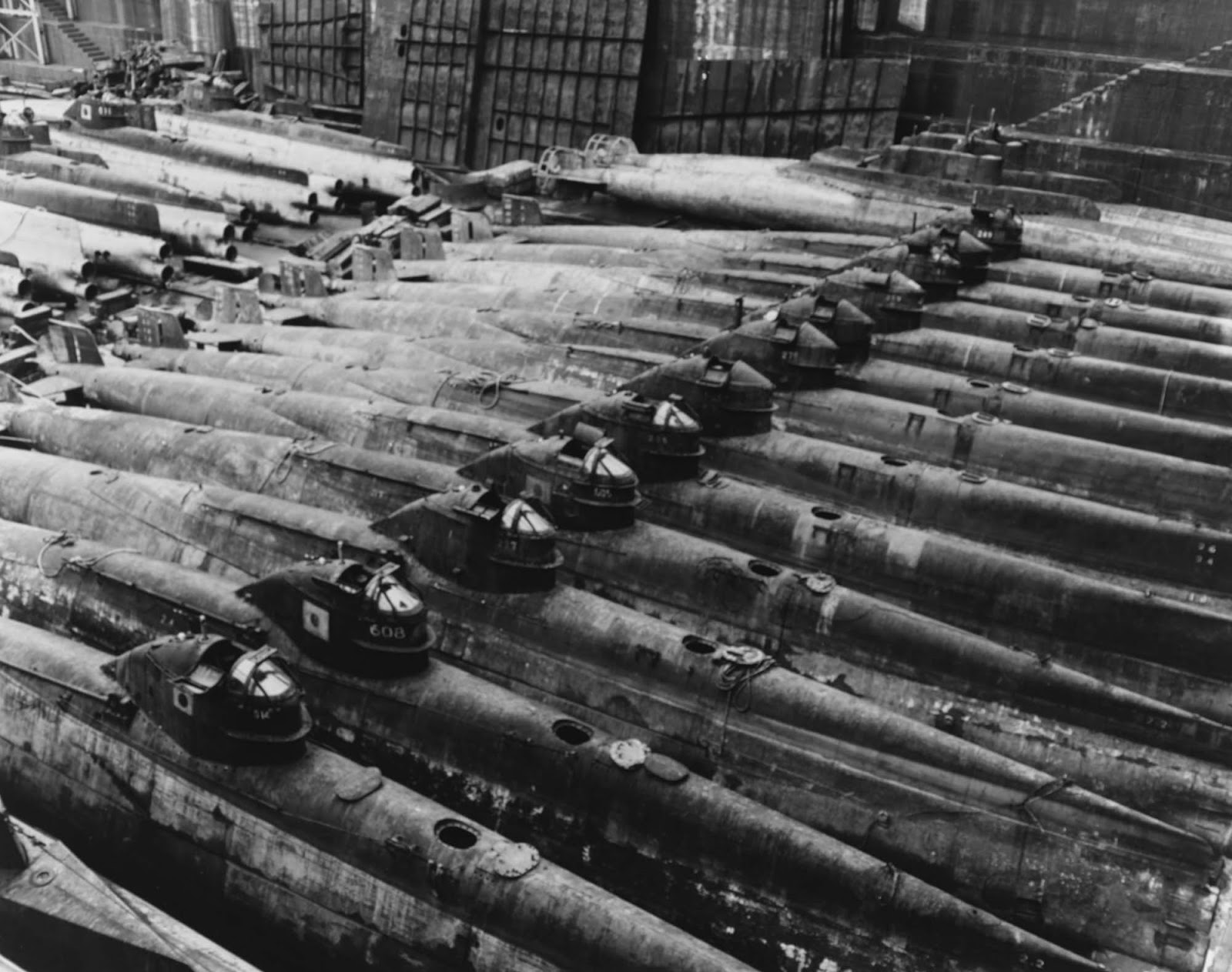 Many of these boats have numbers (possibly in the Ha series?) painted on their conning towers. The two boats in the upper right appear to have an enlarged conning tower, shortened hull superstructure and shrouded propellers.