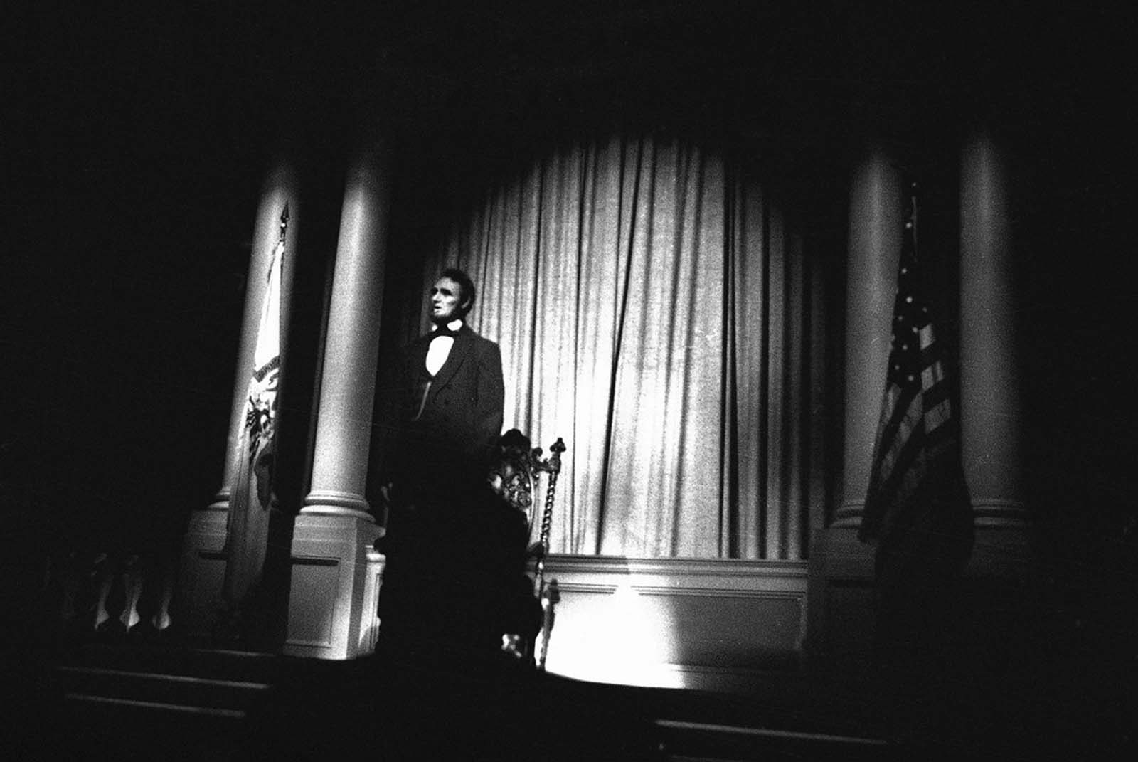 An audio-animatronic Abraham Lincoln, in his familiar dark suit with facial features based on an actual mask of the President rises from a seated position at the start of a nine-minute performance and walks toward the audience at the Illinois Pavilion at the New York World's Fair, May 15, 1964. The six-foot 4-inch figure was created by Walt Disney.