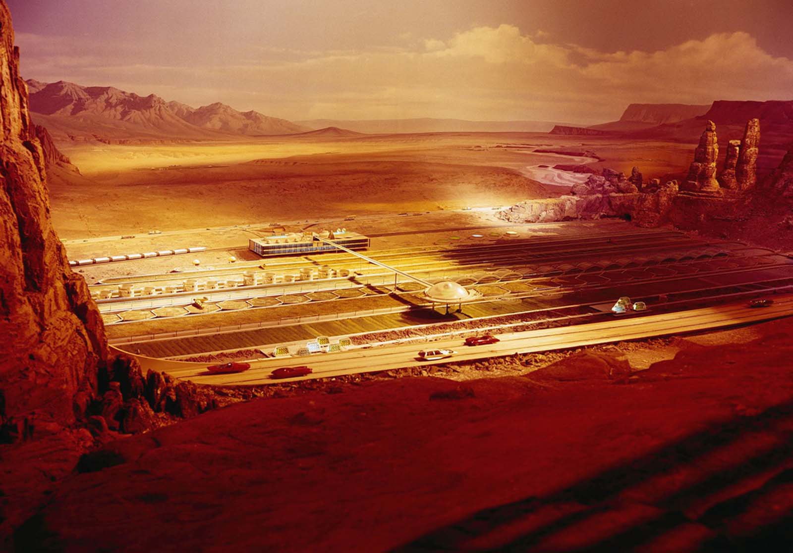 A future vision of the American Southwest in the Futurama exhibit in the General Motors Pavilion. Crops thrive in soil irrigated by desalted sea water. Machines operated by remote control plant and harvest the crops.