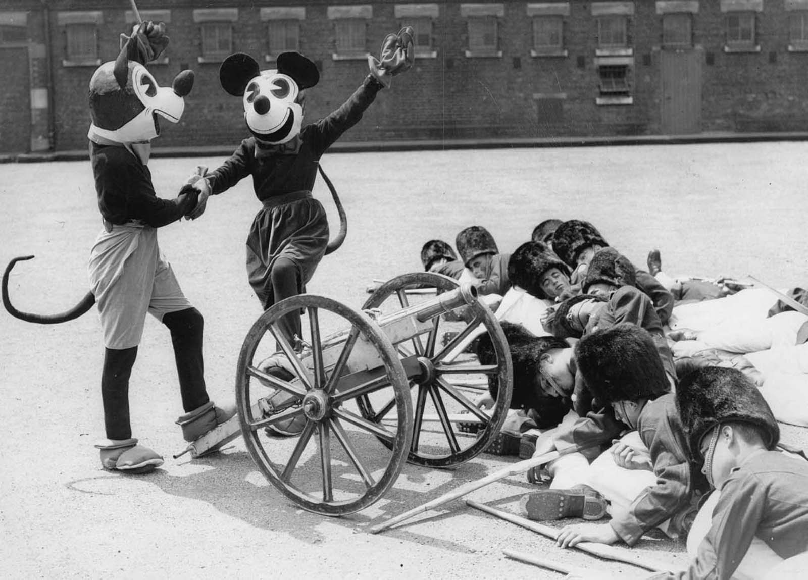 Mickey and Minnie Mouse at a dress rehearsal of the Woolwich Searchlight Tattoo, London. 1933.