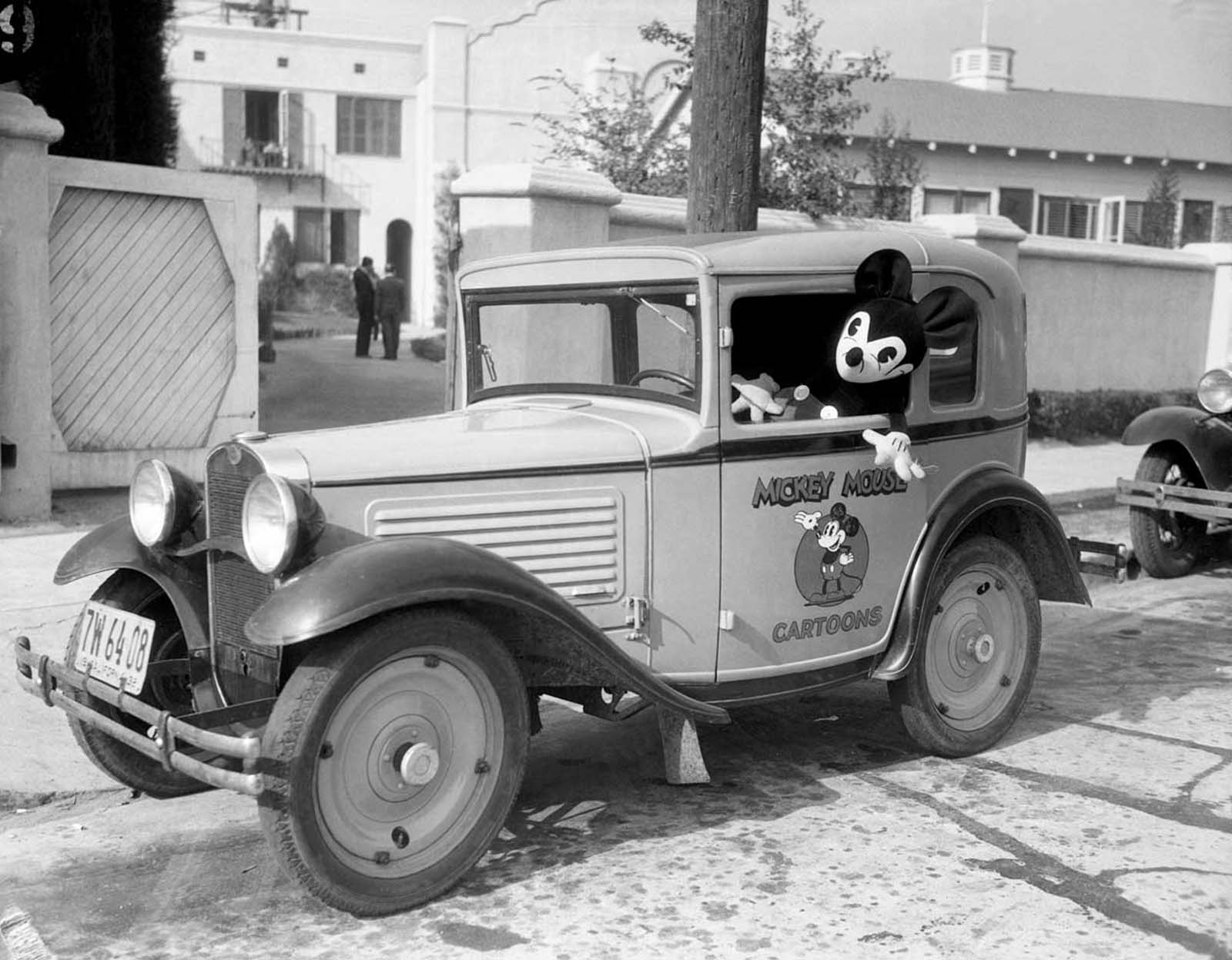 Mickey at the wheel of his own car, bearing his personal coat of arms, at the studio. 1933.