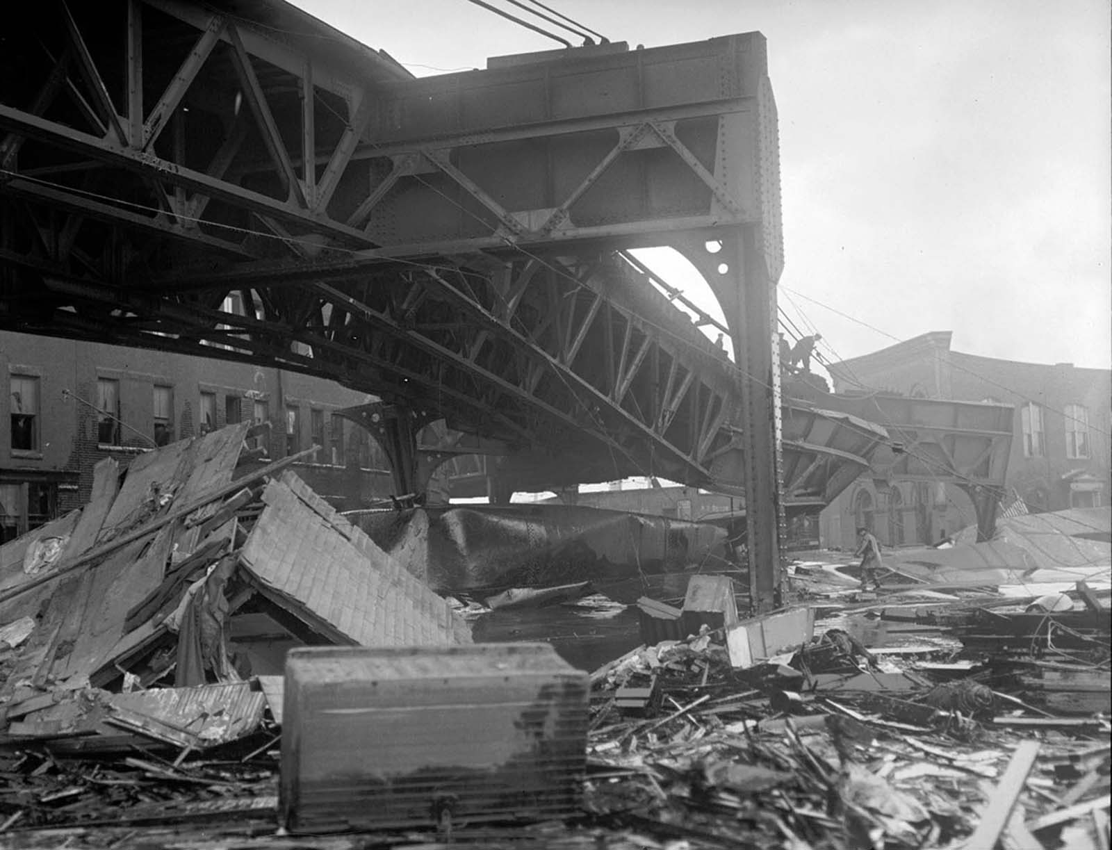 Some of the wreckage caused by the explosion of the molasses storage tank in Boston on January 15, 1919, including damage to the steel support of the elevated train bridge.