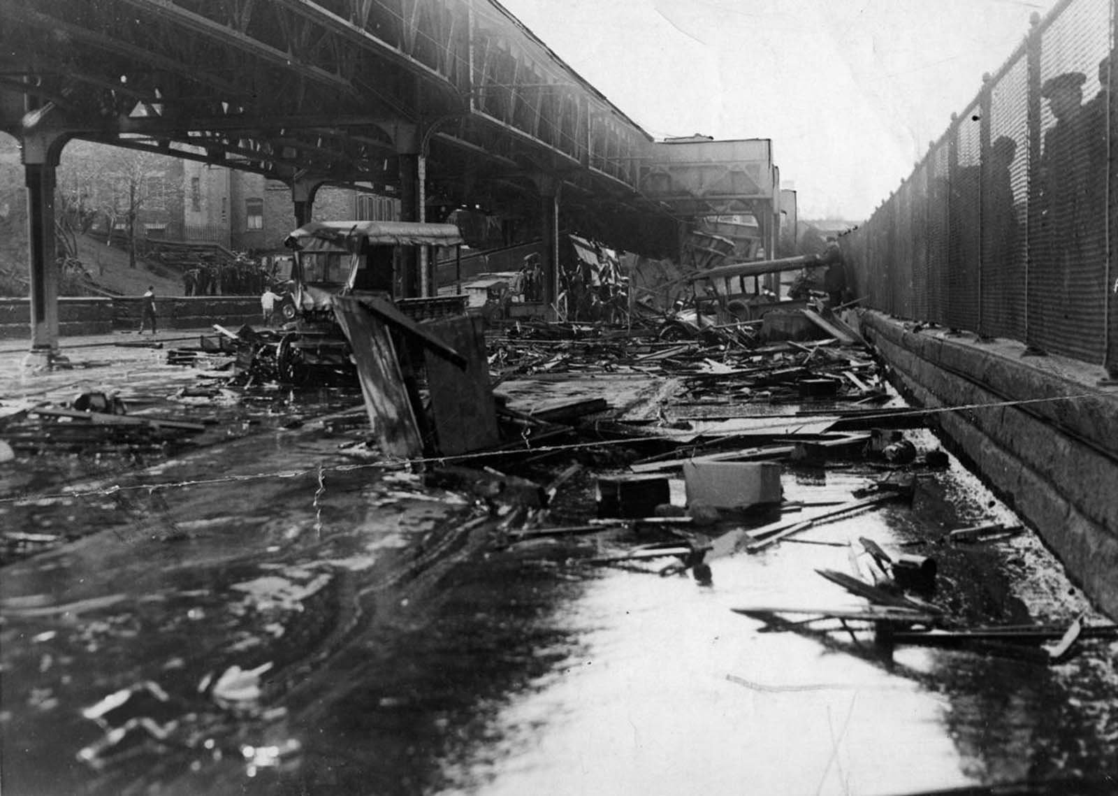 Smashed vehicles and debris sat in a puddle of molasses on Commercial Street, the day after a giant tank in the North End burst.