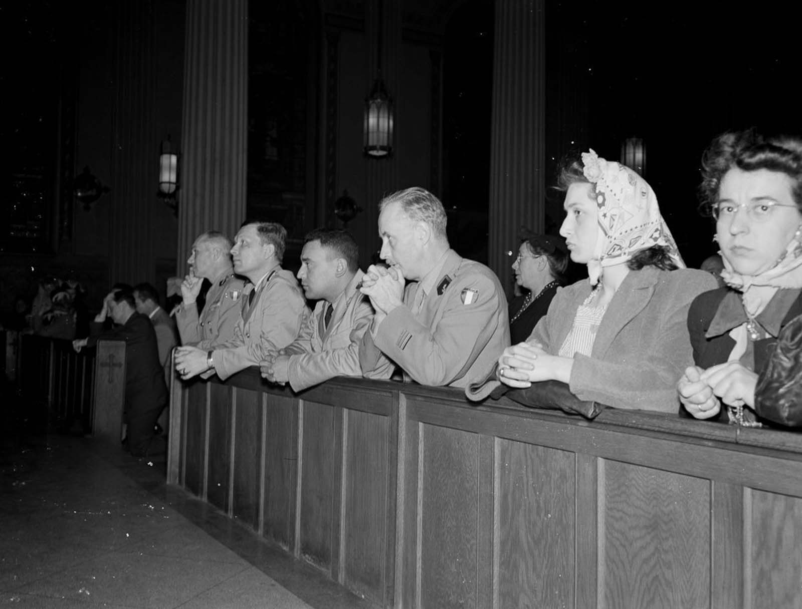 Worshippers pray at noon mass at St. Vincent de Paul's church on 23rd Street.