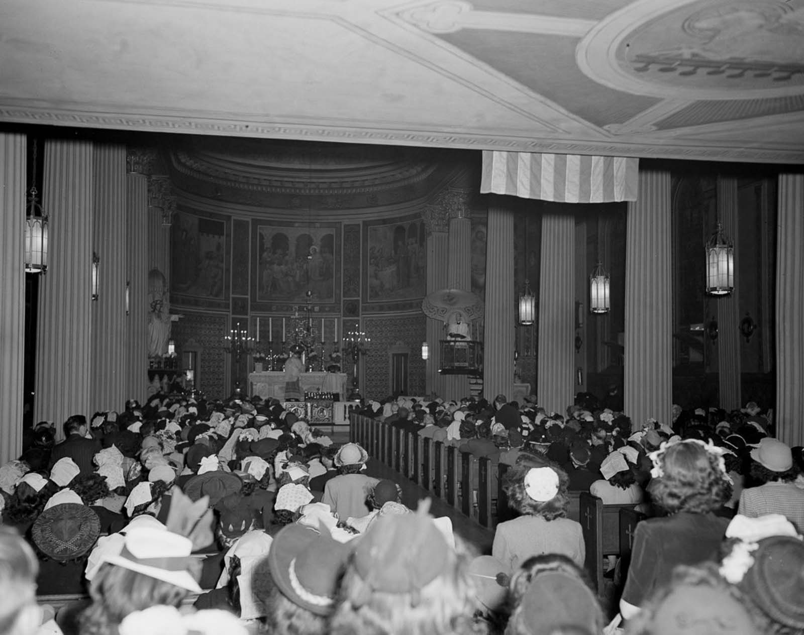 The packed noon mass at St. Vincent de Paul's church.