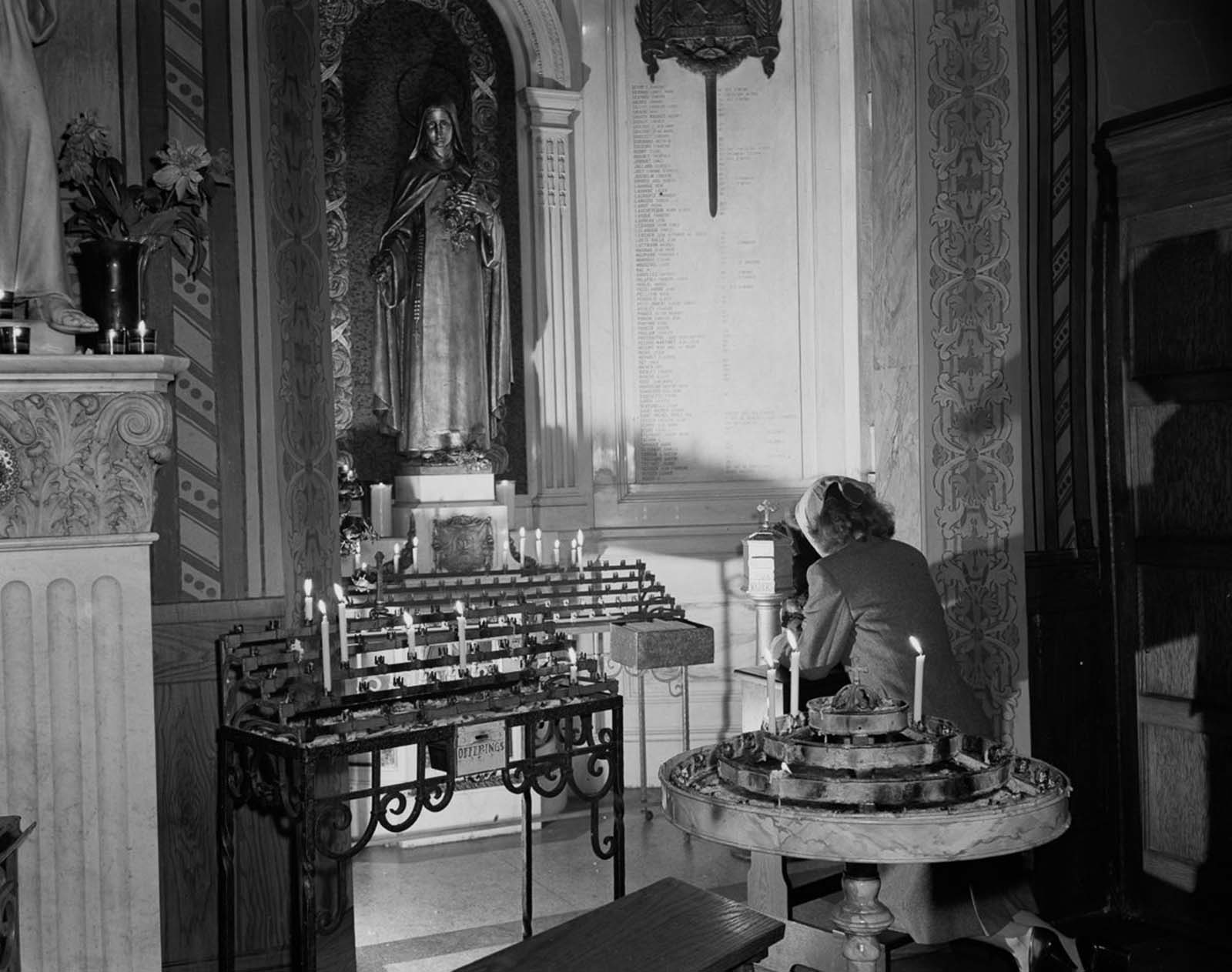 A woman prays at St. Vincent de Paul's church on 23rd Street.