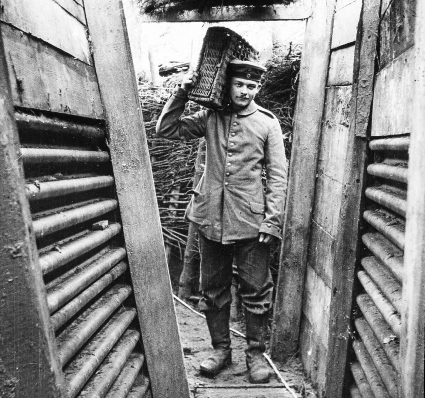 Walter Kleinfeldt, pictured carrying ammunition in a Somme trench, joined a German gun crew in 1915 and fought at the Somme aged just 16, taking pictures of life on the frontline with his Contessa camera.