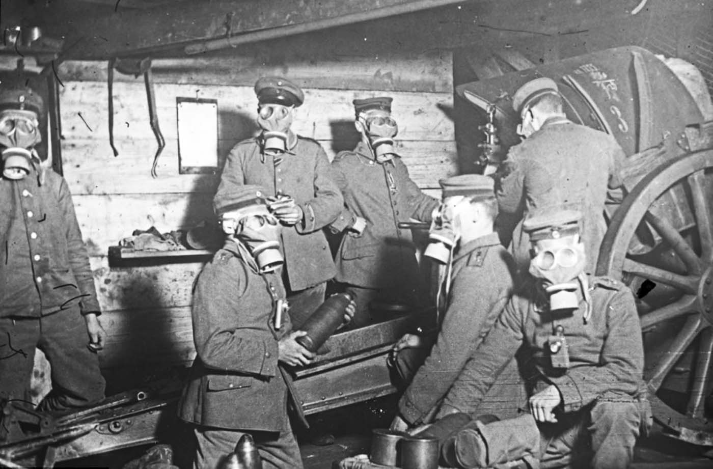 Constantly under threat: Gas attacks were a frequent menace in the Somme during the war so this group wear masks as they load shells into their gun in 1916.