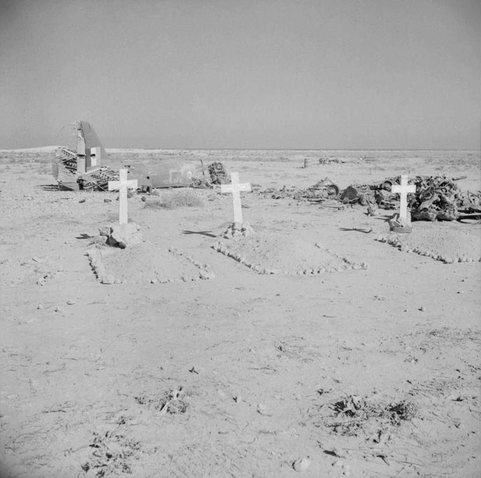 The graves of three aircrew of No. 39 Squadron RAF, buried by the Germans, lie in front of the wreckage of their Martin Maryland Mark II south-west of Gazala.