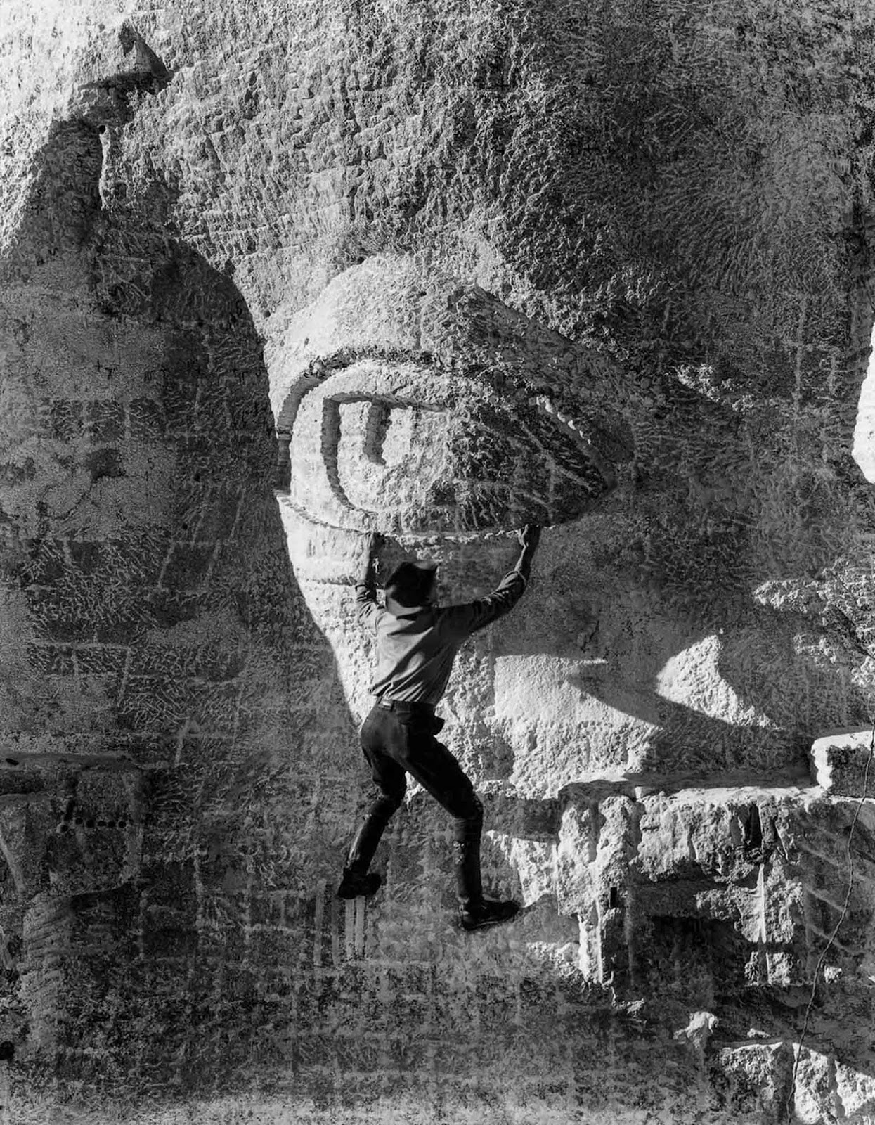 A stone carver hangs on to Thomas Jefferson's eyelid. 1936.