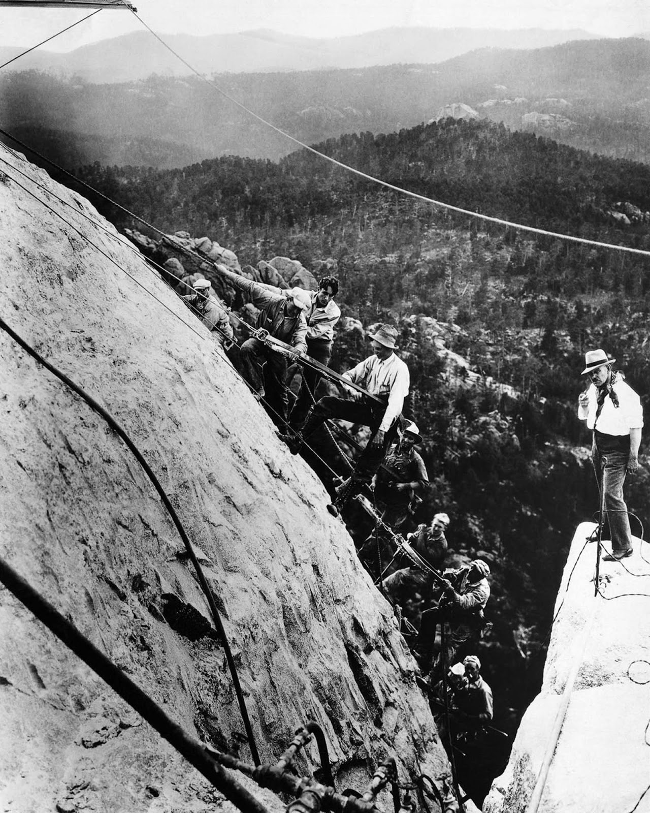 Project leader Gutzon Borglum (right) supervises his team of sculptors on what will become George Washington's forehead. 1929.