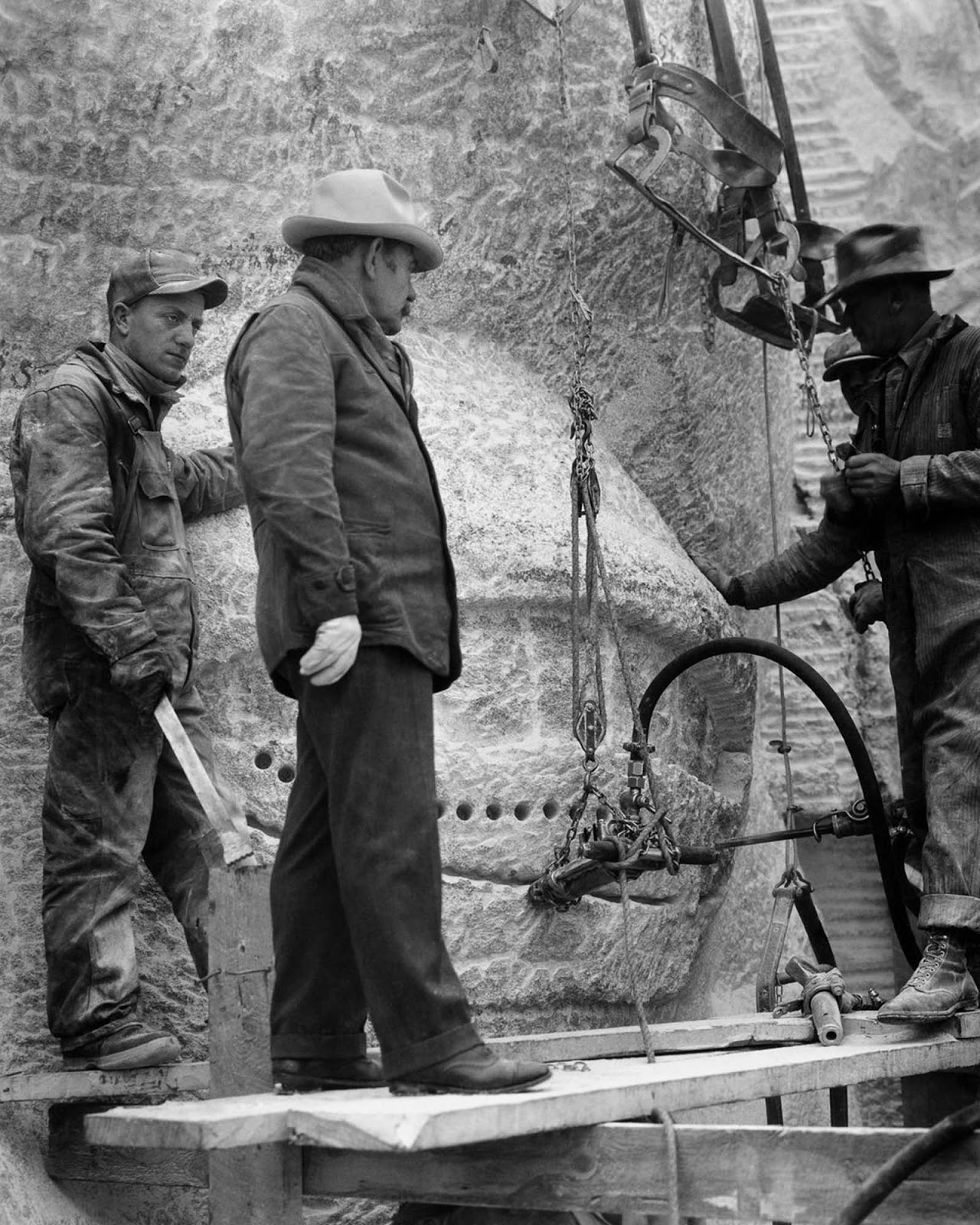 Borglum (center) inspects one of the presidents' eyes. 1937.