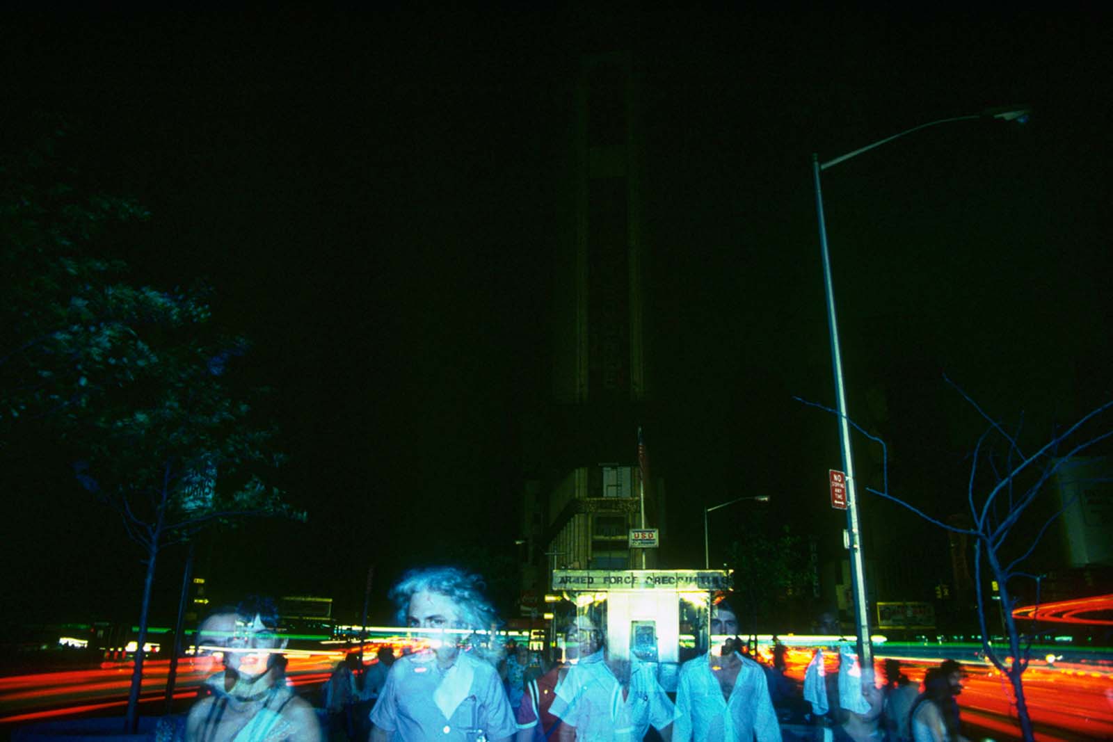 People make their way through a dramatically darkened Times Square.