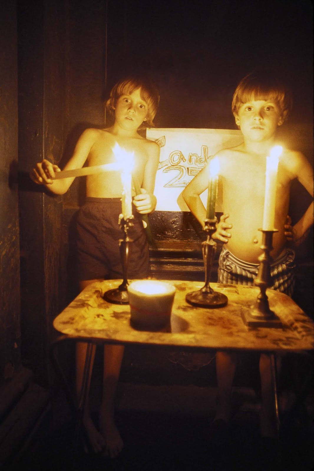 Boys sell candles on a Tribeca sidewalk.