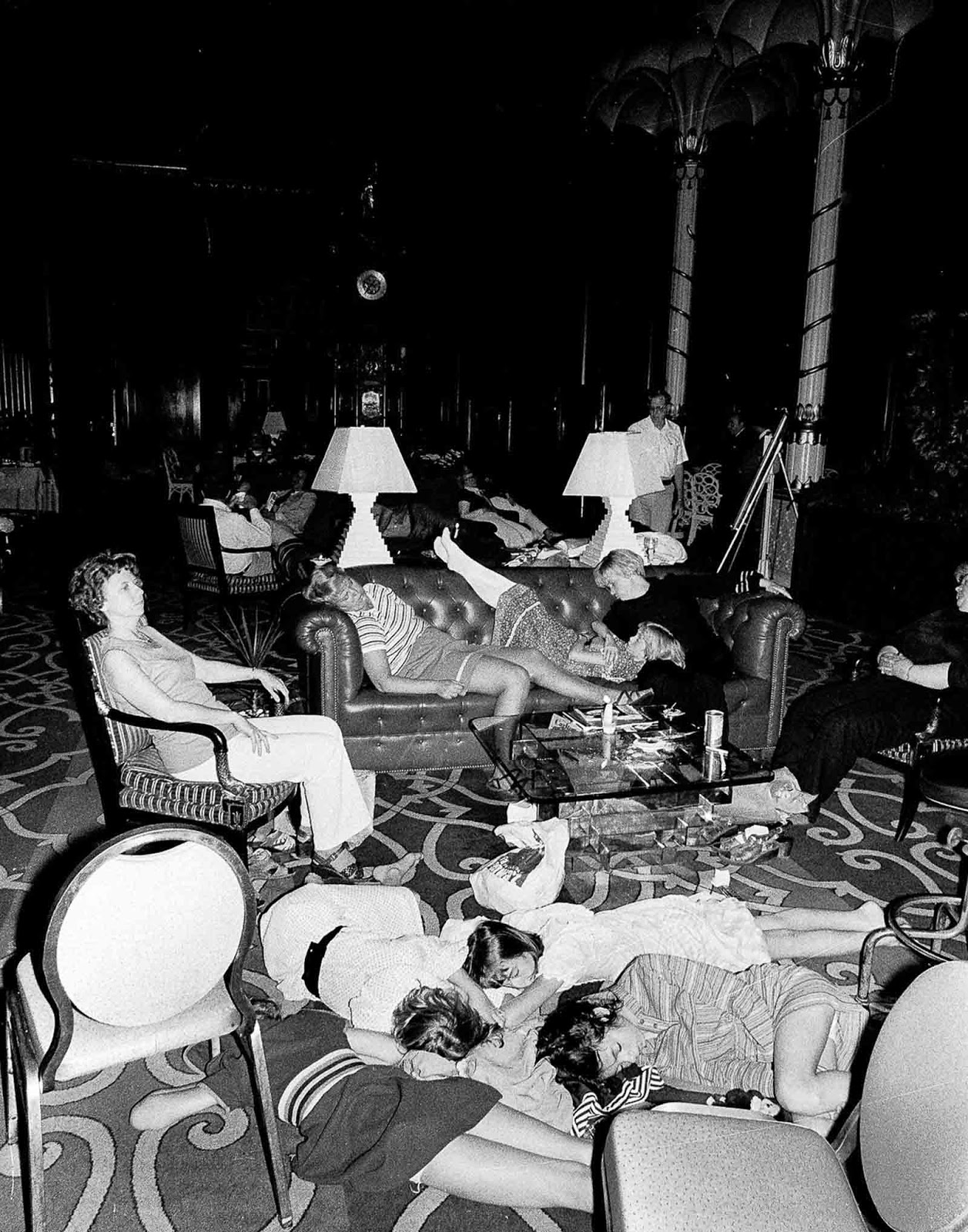Stranded people sleep in the lobby at the Waldorf-Astoria hotel.