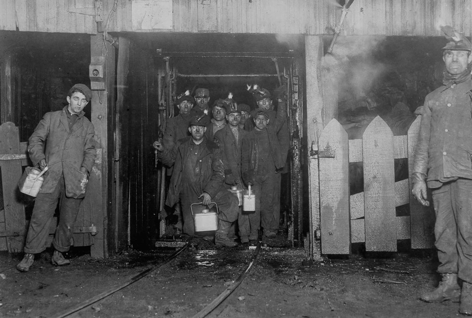 Workers wait for the cage to ascend to the surface at the end of the day. 1910.