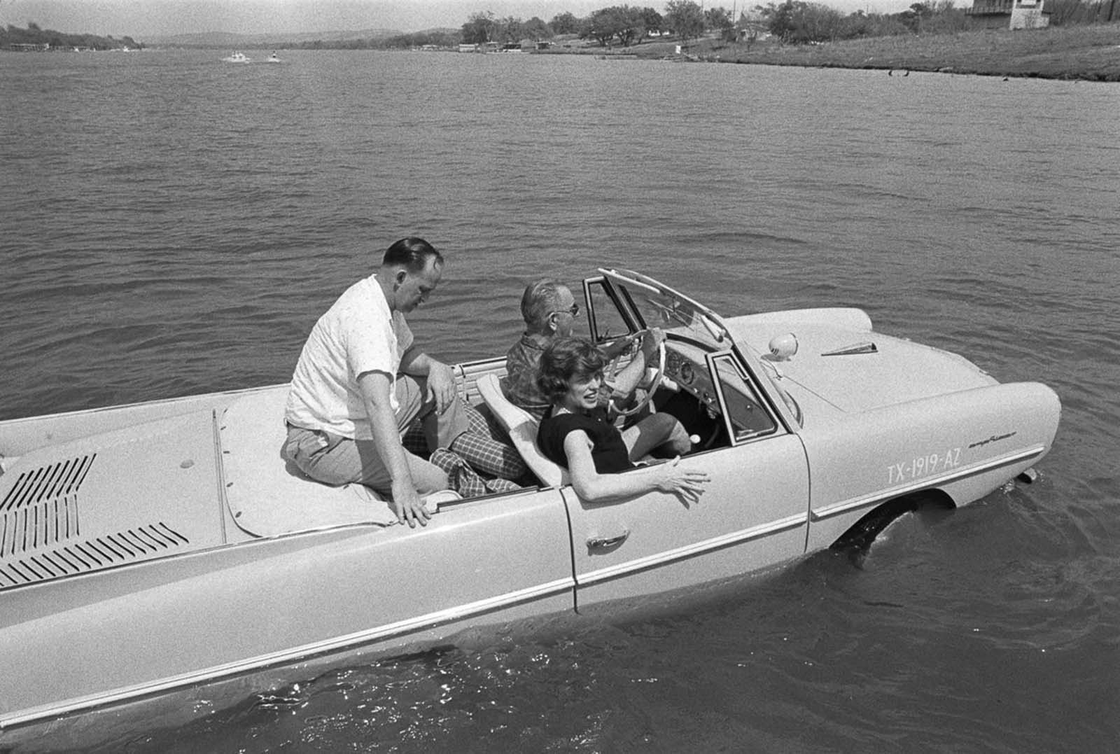 President Lyndon Johnson drives an Amphicar at his Texas ranch. 1965.