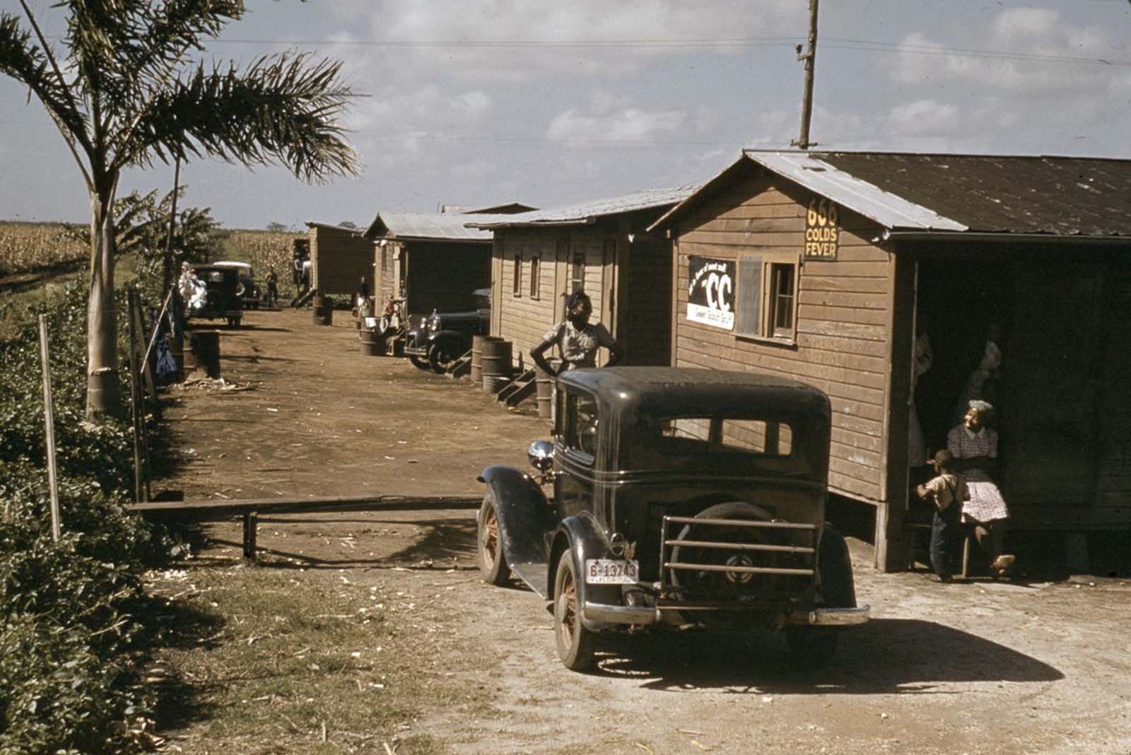 Houses condemned by the Board of Health remain occupied by migrant sharecropper families in Belle Glade, Florida. 1941.