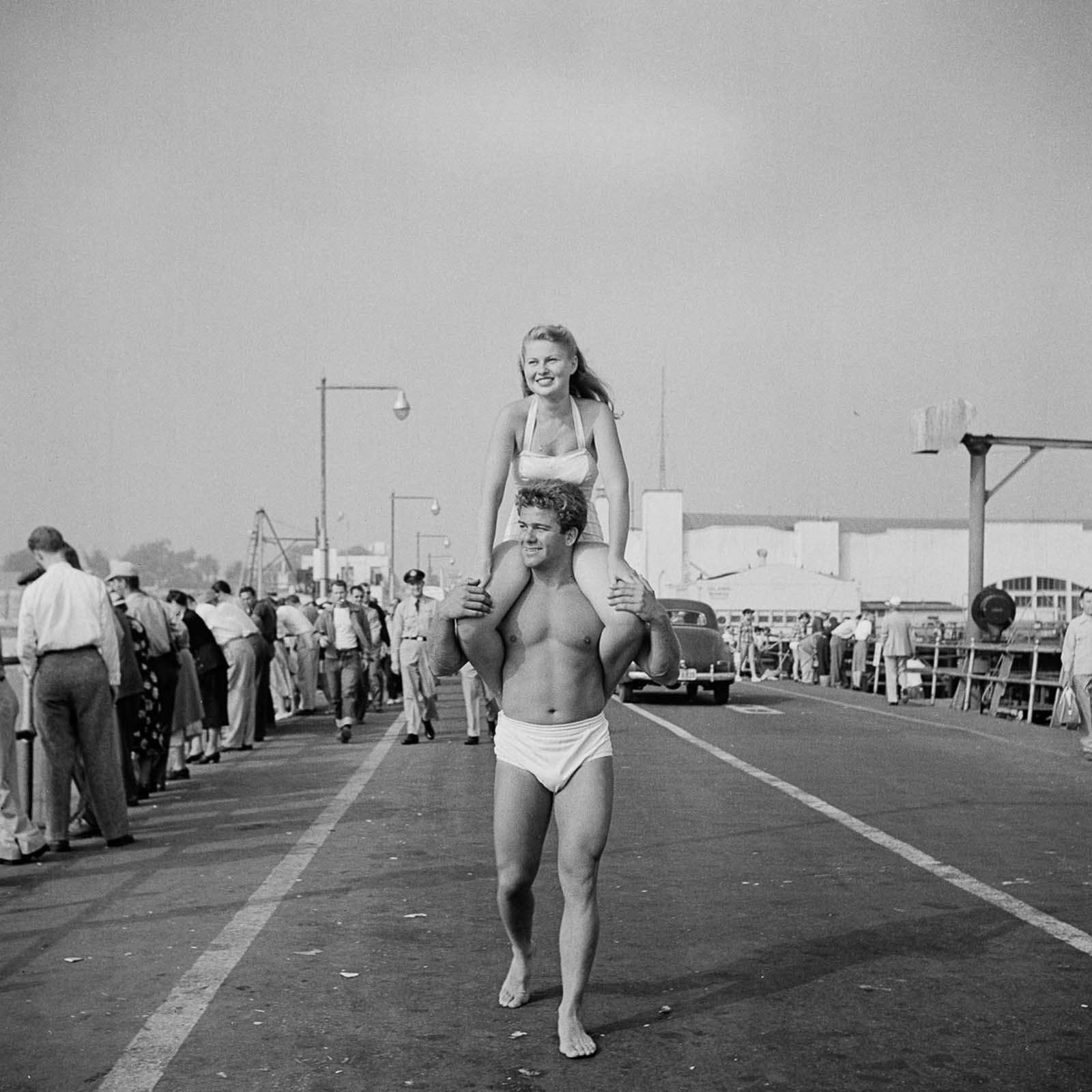The same couple walking around the Muscle Beach.