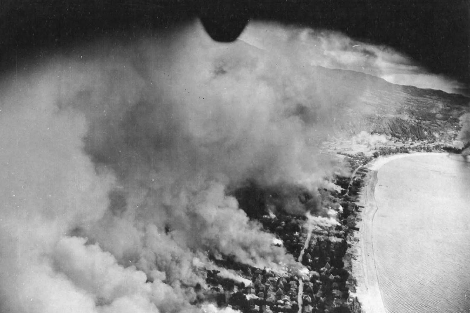 Flames spread through the city of Tarumiza, Kyushu, Japan, after incendiary bombing by the 499th Bomb Squadron, 345th Bomb Group.
