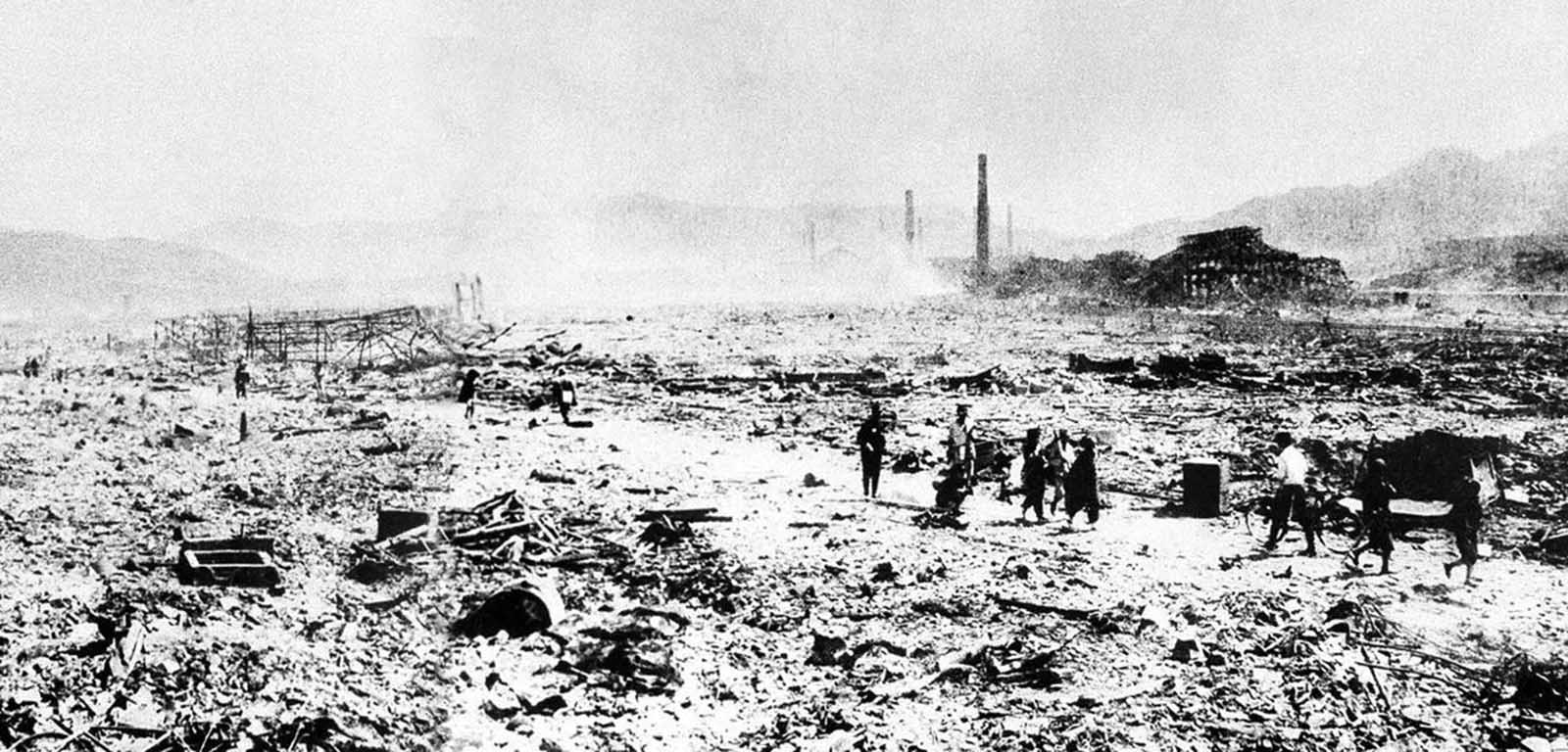 This picture made shortly after the August 9, 1945 atomic bombing, shows workers carrying away debris in a devastated area of Nagasaki, Japan. This picture obtained by the U.S. Army from files of Domei, the official Japanese news agency, was the first ground view of the nuclear destruction in Nagasaki.