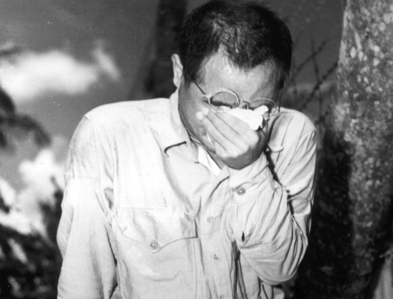 A Japanese prisoner of war at Guam, Mariana Islands, covers his face as he hears Japanese Emperor Hirohito making the announcement of Japan's unconditional surrender on August 15, 1945. World War II had come to an end.