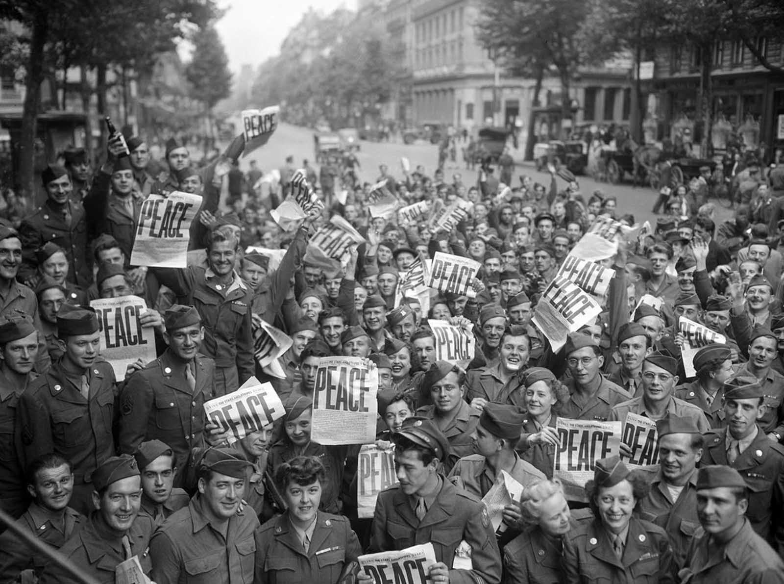 American servicemen and women gather in front of