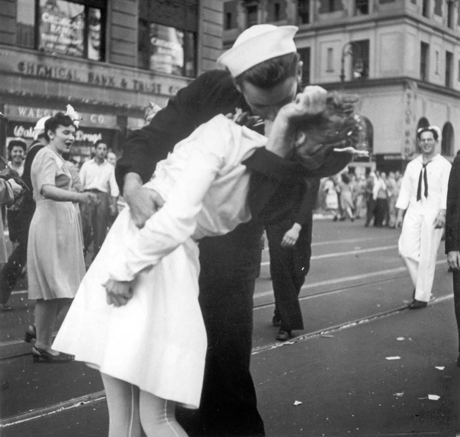 A sailor and a nurse kiss passionately in Manhattan's Times Square, as New York City celebrates the end of World War II on August 14, 1945.