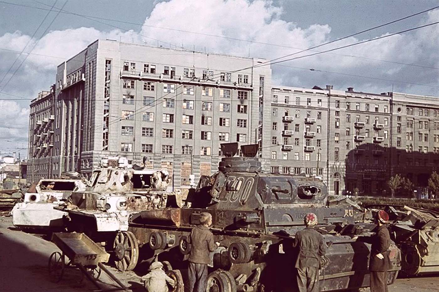 Ukrainian children inspecting a Panzer III wreck.