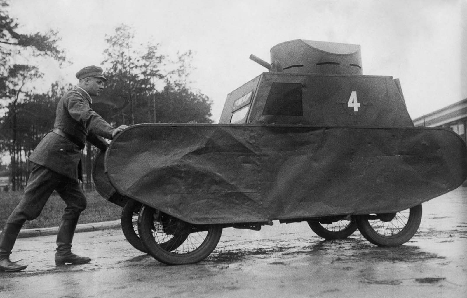 A German soldier pushes a dummy tank. 1931.