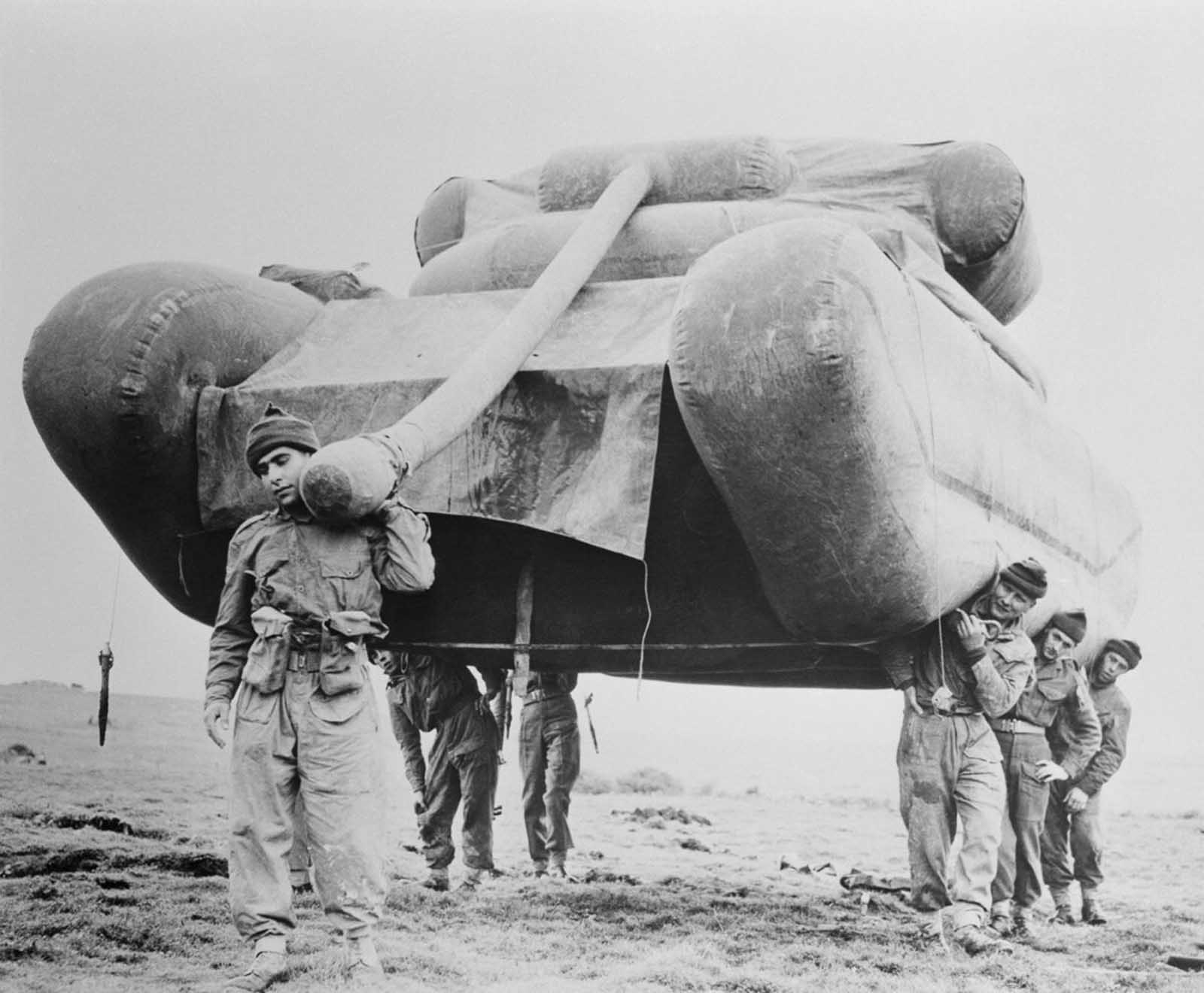 British soldiers hoist an inflatable dummy tank during exercises on Salisbury Plain (after the war ended).