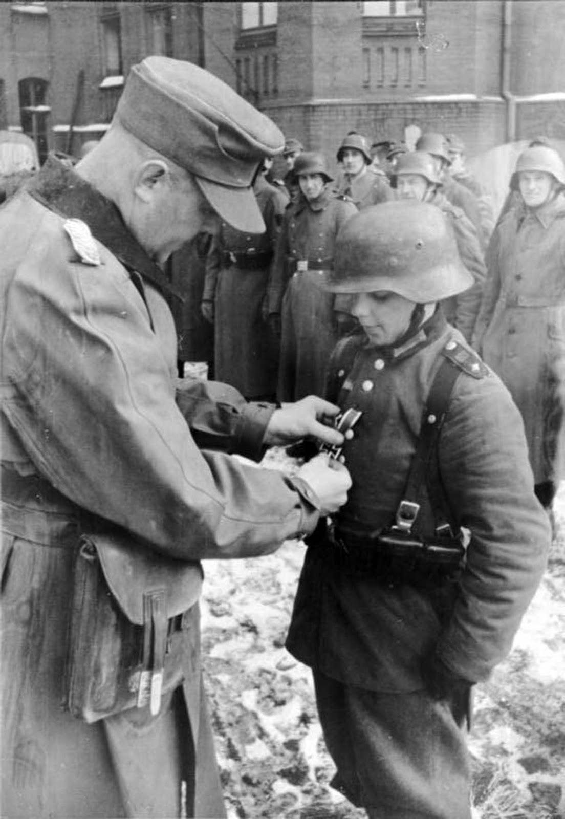 Artur Axmann, leader (Reichsjugendführer) of the Hitler Youth (Hitlerjugend), redecorating Willi Hübner.