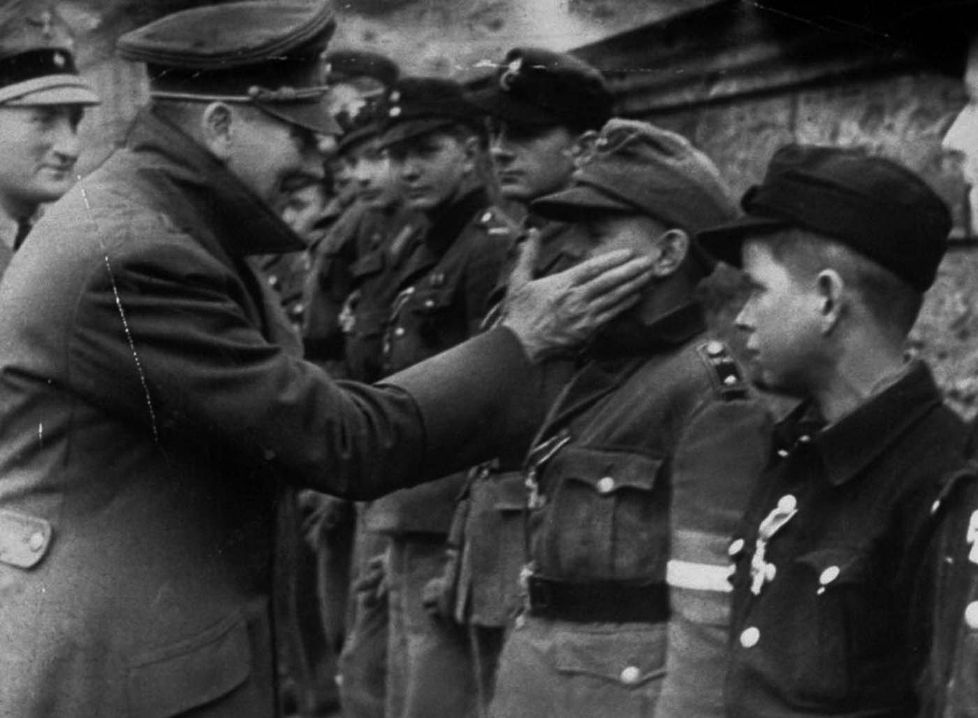 Adolf Hitler touches the face of Wilhelm