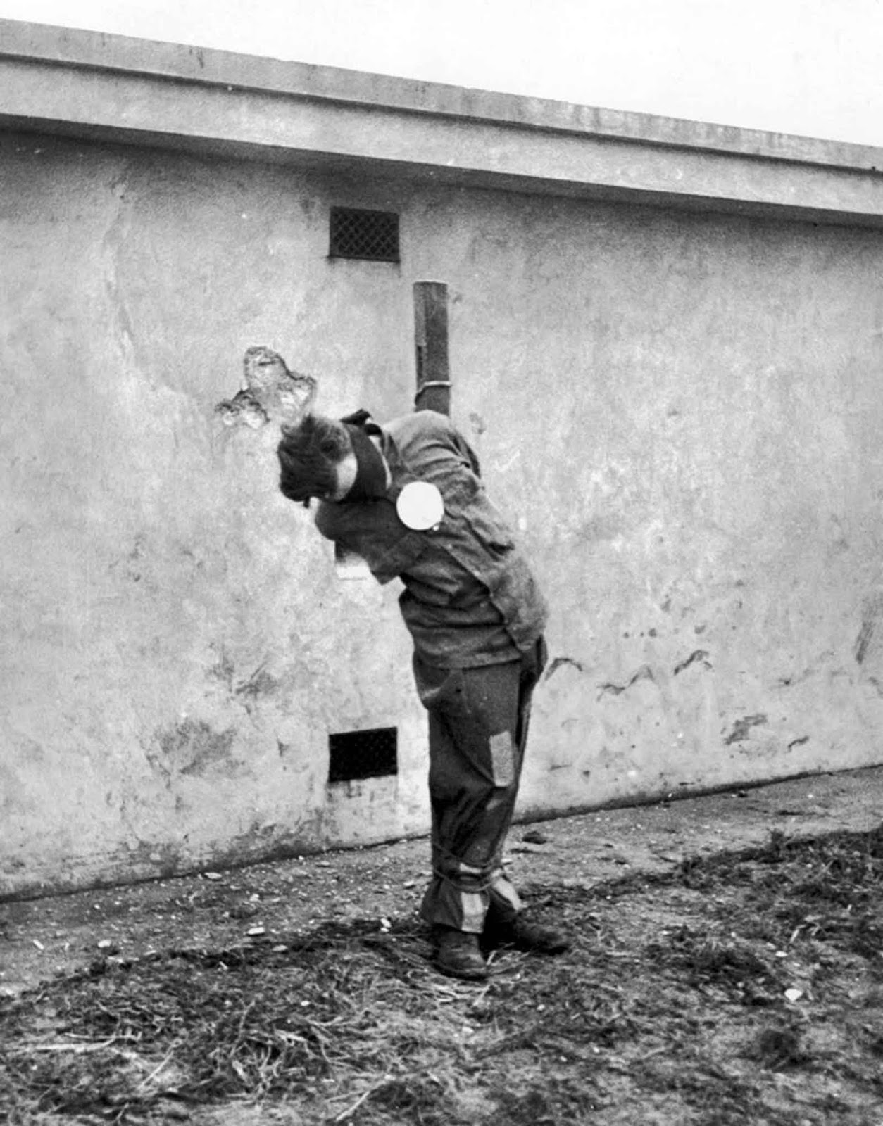 The prisoners were blindfolded and a large white paper target was pinned over their heart.