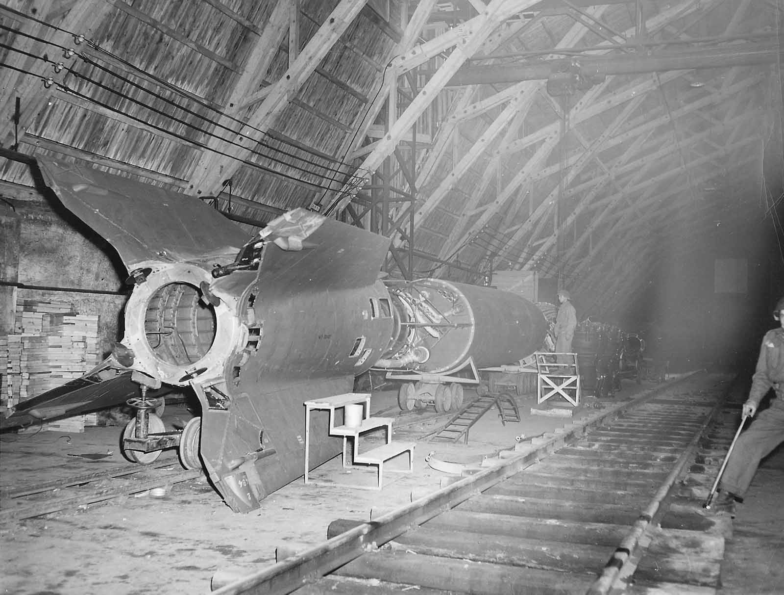U.S. soldiers inspect a German 'V-2' rocket at the factory. Kleinbodungen, Germany, 1945.