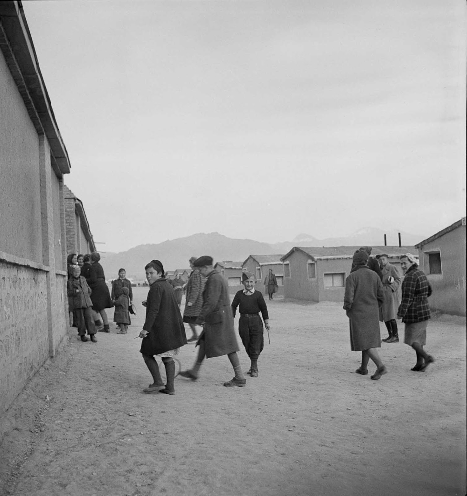 Polish children play among the dormitories of a Red Cross camp.