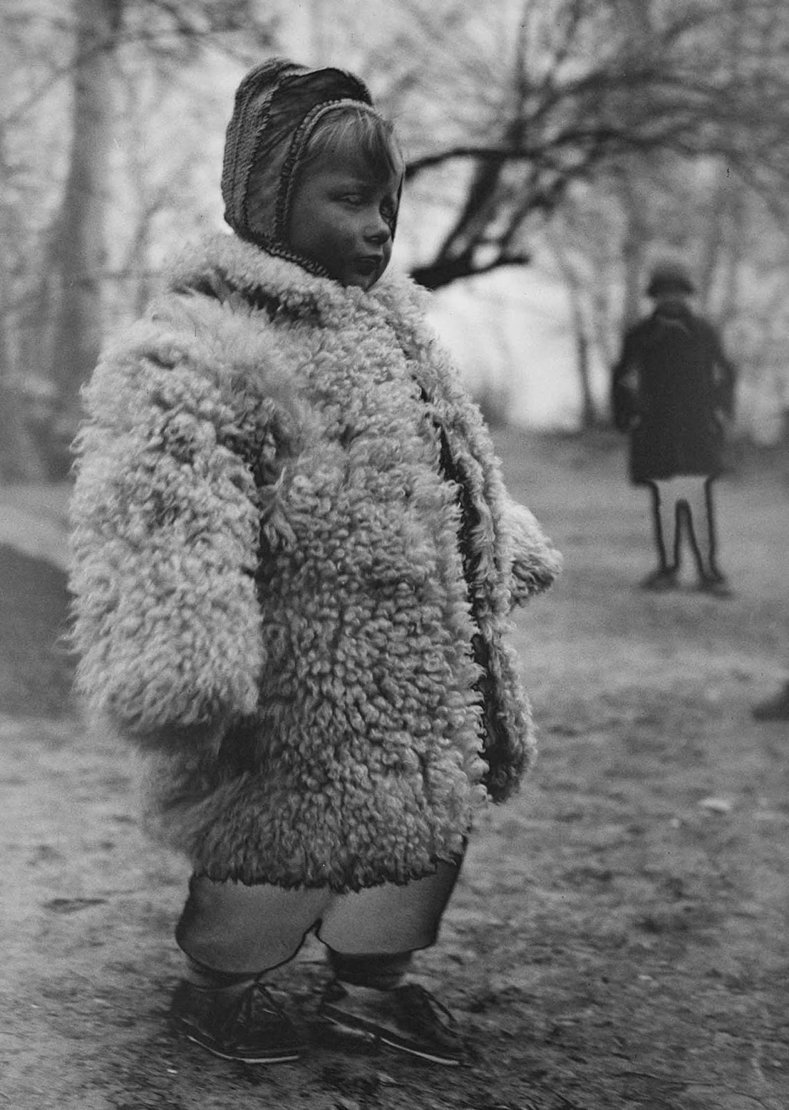 A Polish girl wears a heavy sheepskin coat at a refugee camp.