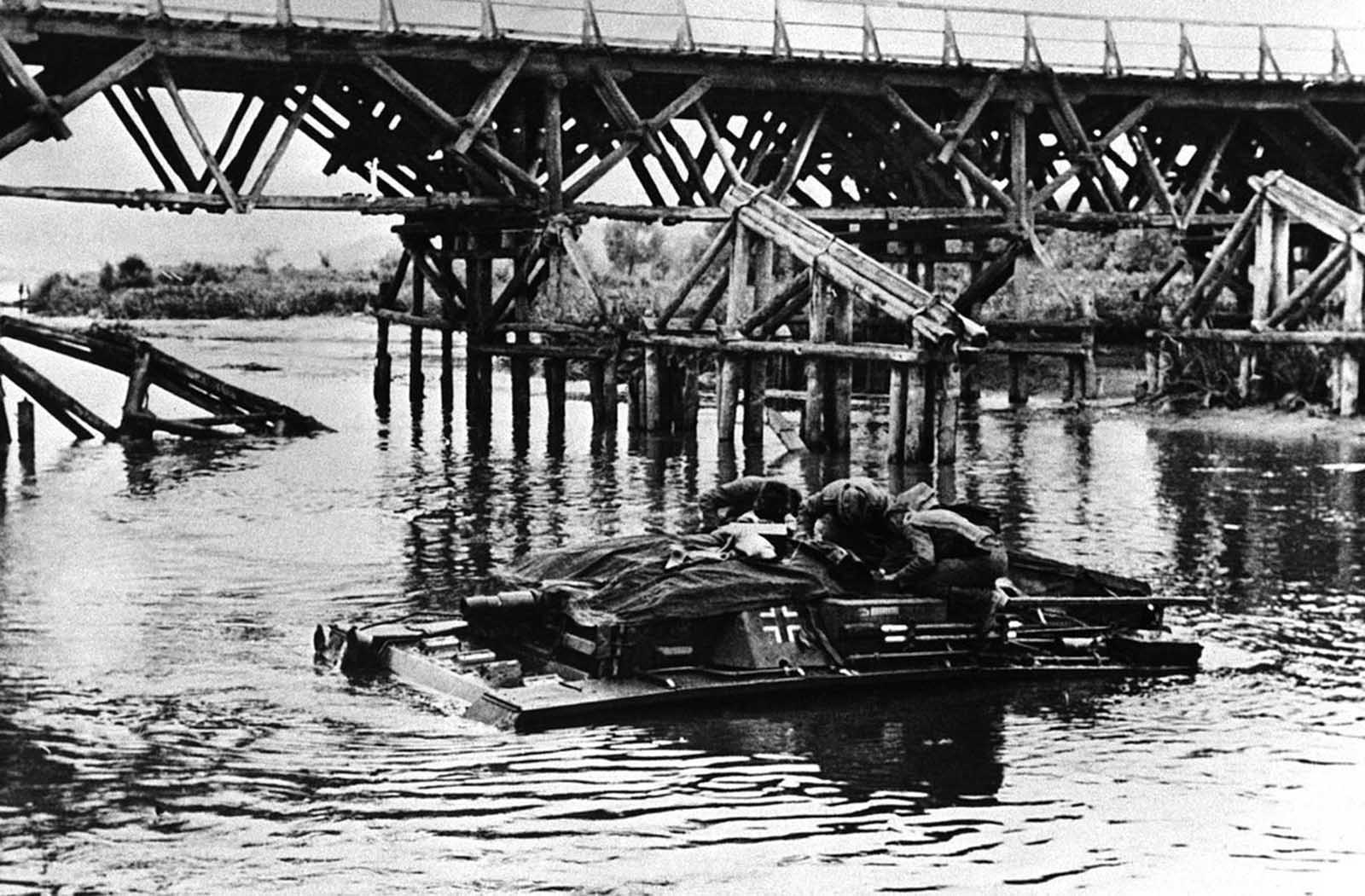German soldiers crossing a Russian River on their tank on August 3, 1942.