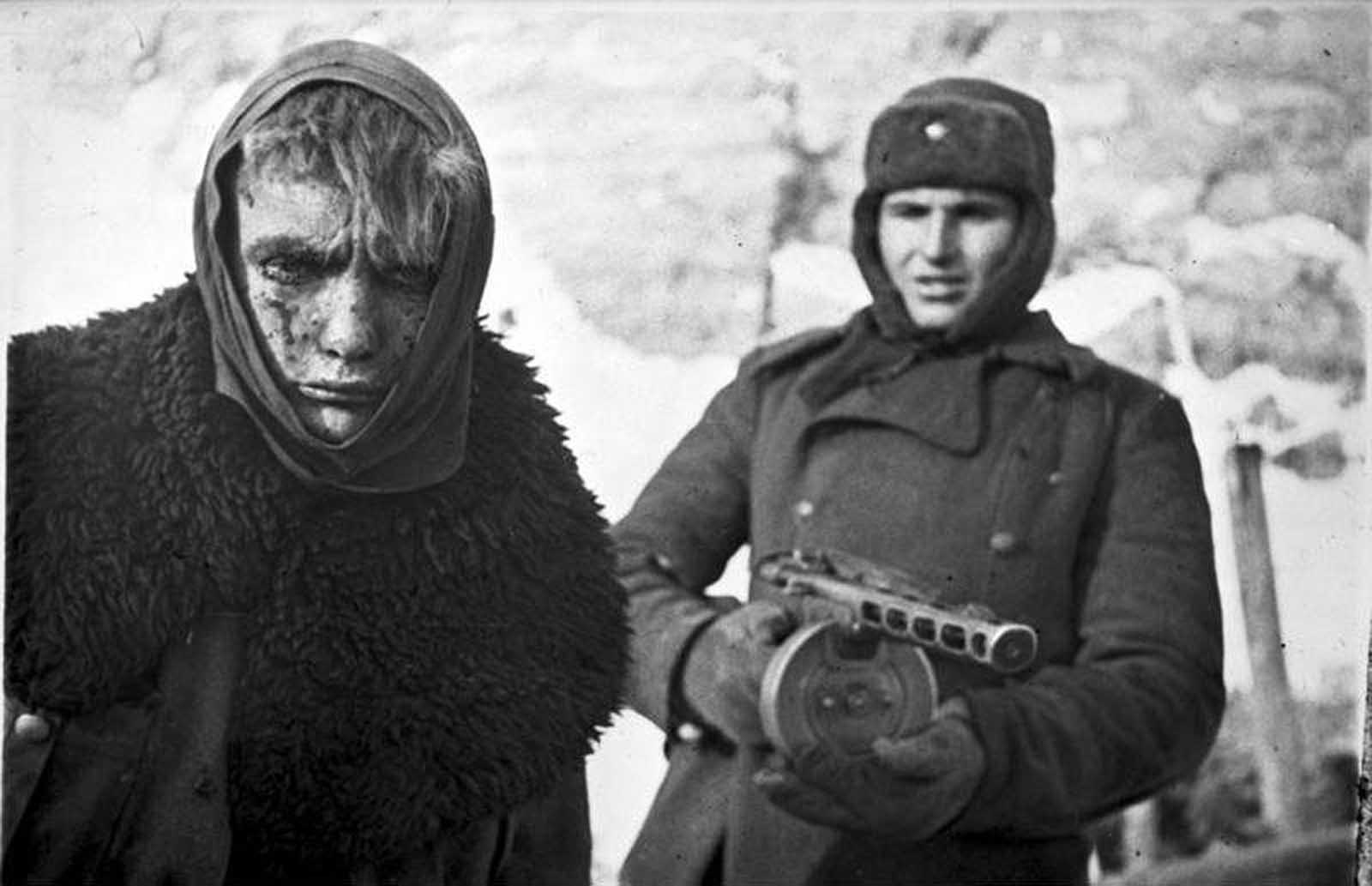 In February of 1943, a Soviet soldier stands guard behind a captured German soldier. Months after being encircled by the Soviets in Stalingrad, the remnants of the German Sixth Army surrendered, after fierce fighting and starvation had already claimed the lives of some 200,000.