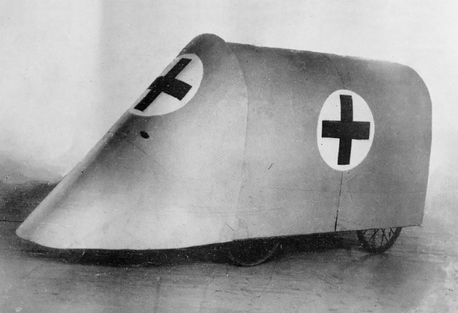 An experimental Red Cross vehicle designed to protect the wounded while gathering them from trenches during World War I, ca. 1915. The narrow wheels and low clearance would likely make this design ineffective in the chaotic and muddy front line landscape.