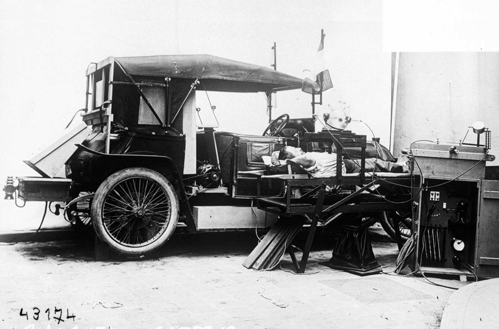 A patient is examined in a mobile radiology lab, belonging to the French Army, ca. 1914.