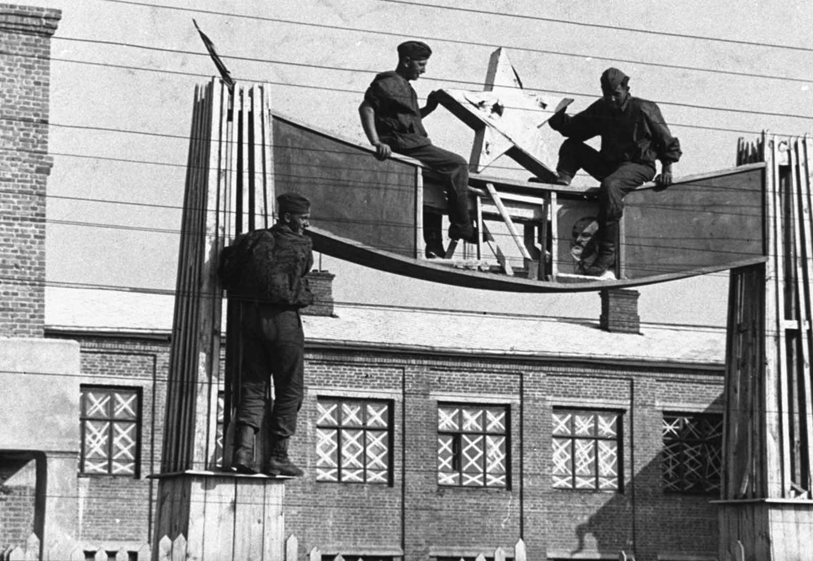 German soldiers remove one of many Soviet national emblems during their drive to conquer Russia on July 18, 1941.