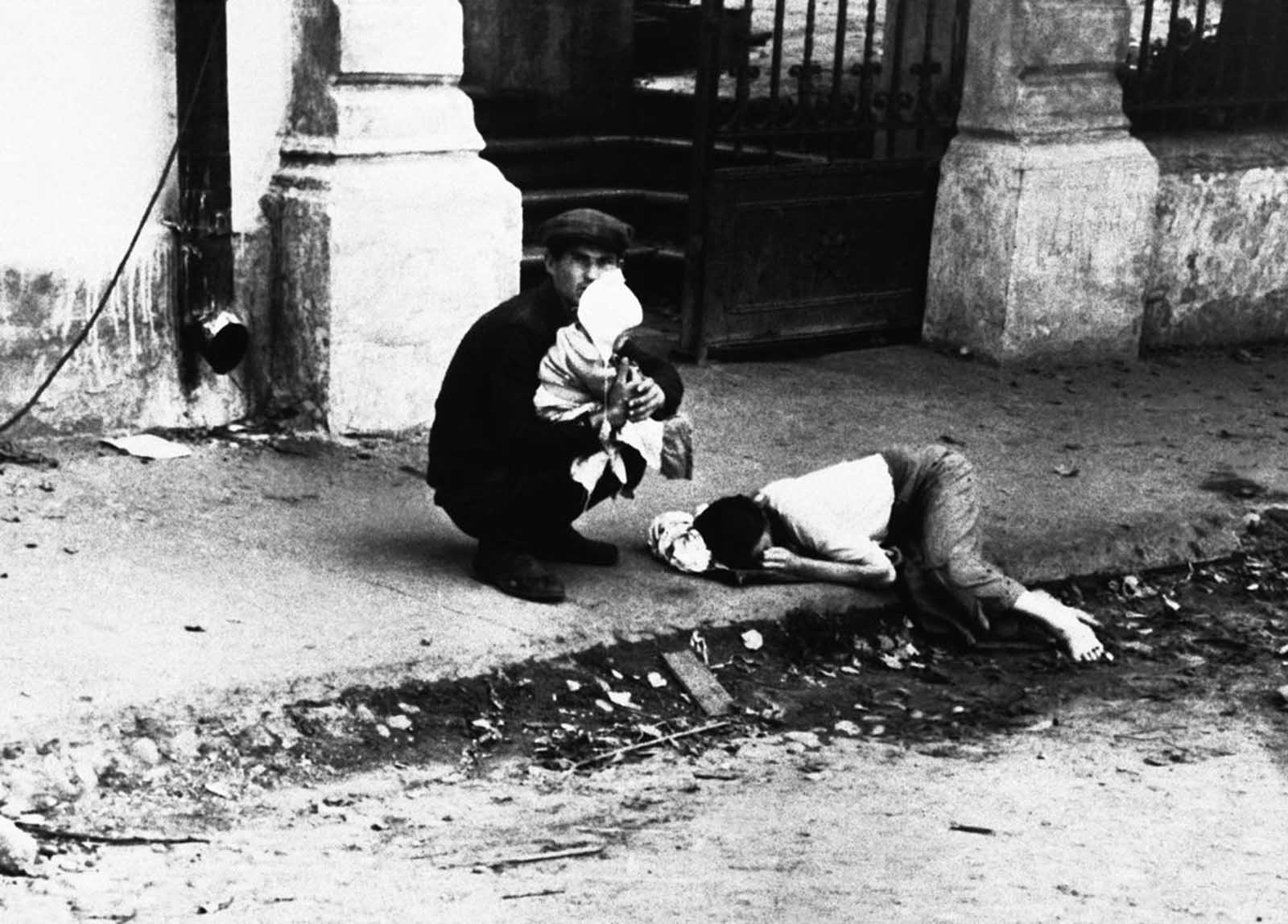 A man, his wife, and child are seen after they had left Minsk on August 9, 1941, when the German army swarmed in. The original wartime caption reads, in part:
