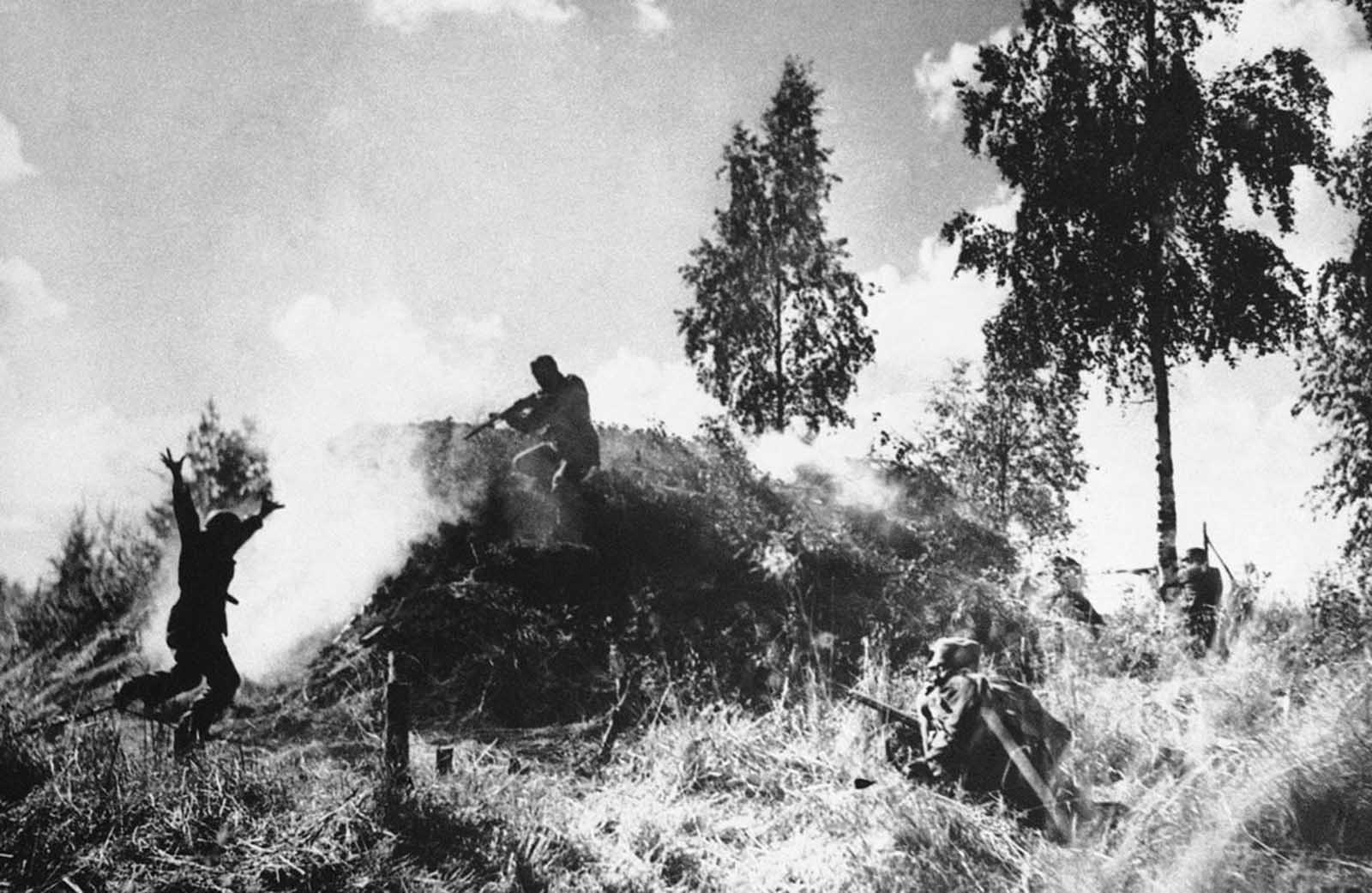 Finnish soldiers storm a soviet bunker on August 10, 1941. One of the Soviet bunker's crew surrenders, left.