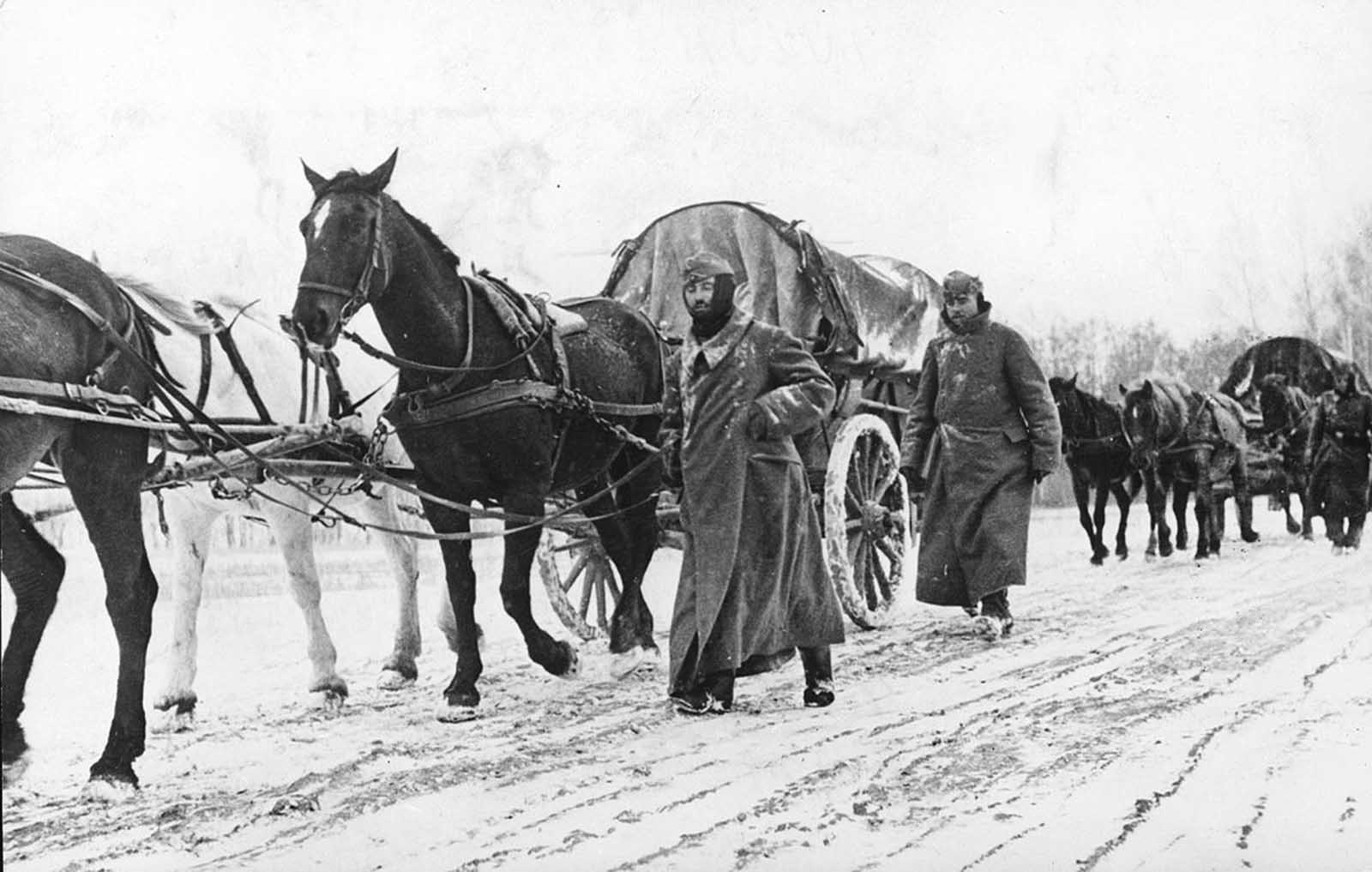 German infantrymen in heavy winter gear march next to horse-drawn vehicles as they pass through a district near Moscow, in November 1941. Winter conditions strained an already thin supply line, and forced Germany to halt its advance - leaving soldiers exposed to the elements and Soviet counterattacks, resulting in heavy casualties and a serious loss of momentum in the war.